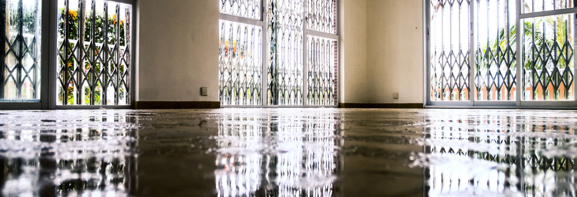Standing water covering the floor of a South Walton vacation rental after an undetected supply line leak